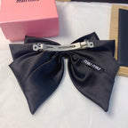 Satin Logo Bow Hair Clip — Elegant & Versatile